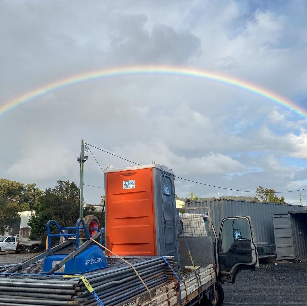A Truck With A Rainbow In The Sky Behind It — Coffs Temporary Fencing Pty Ltd In Moonee Beach, NSW