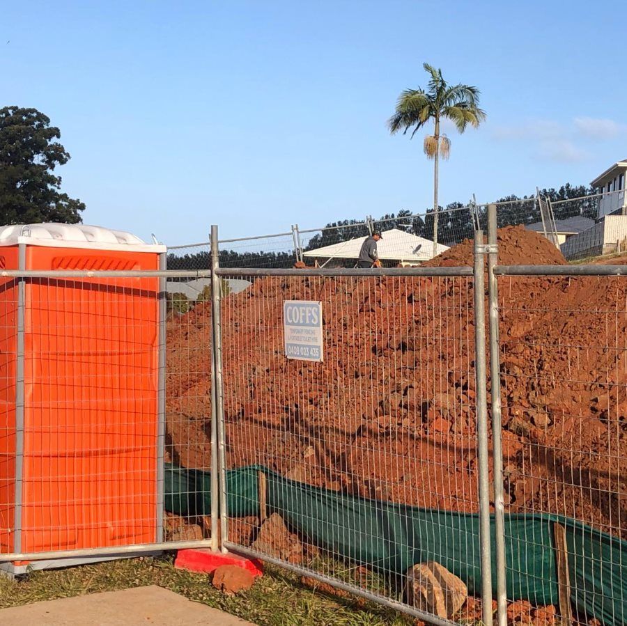 A Fence With A Sign That Says Coffs On It — Coffs Temporary Fencing Pty Ltd In Bellingen, NSW