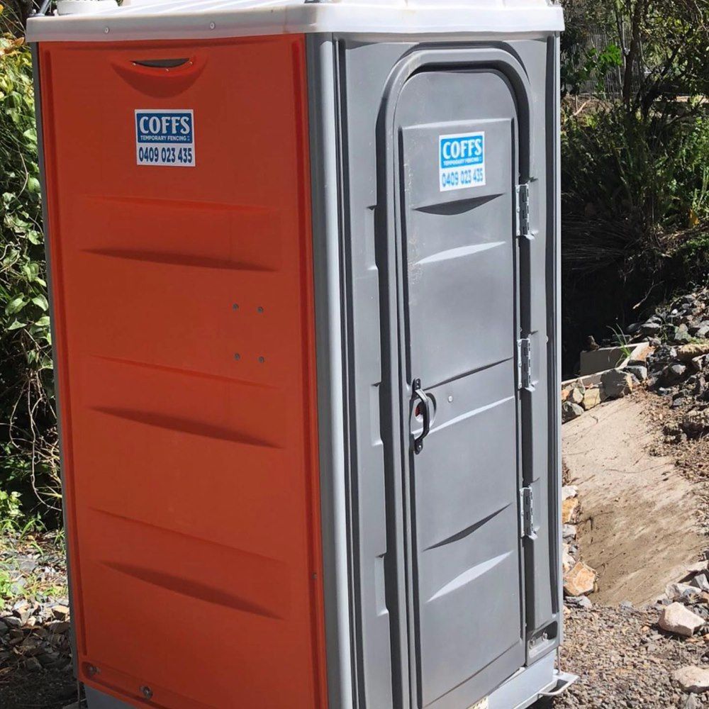 An Orange And Gray Portable Toilet That Says Coffs On It — Coffs Temporary Fencing Pty Ltd In Woolgoolga, NSW