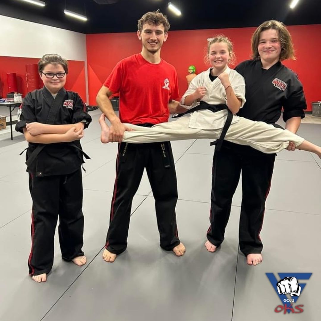 A man in a red shirt is holding a woman 's leg