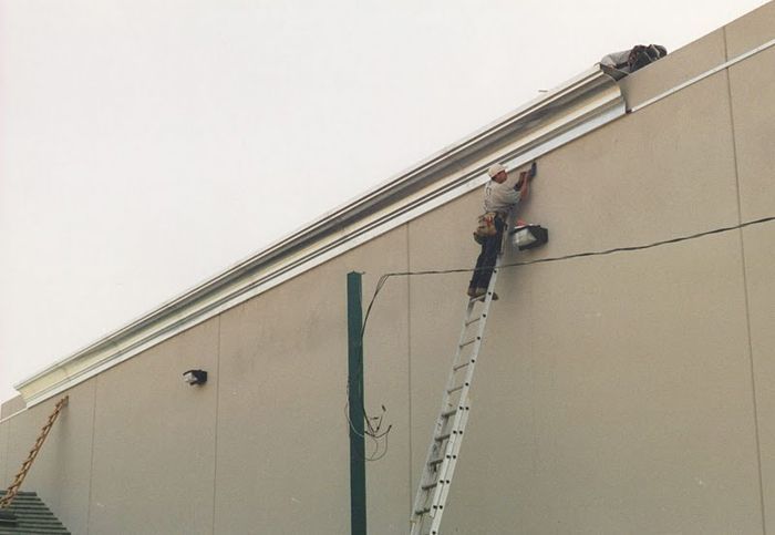 worker installing a gutter