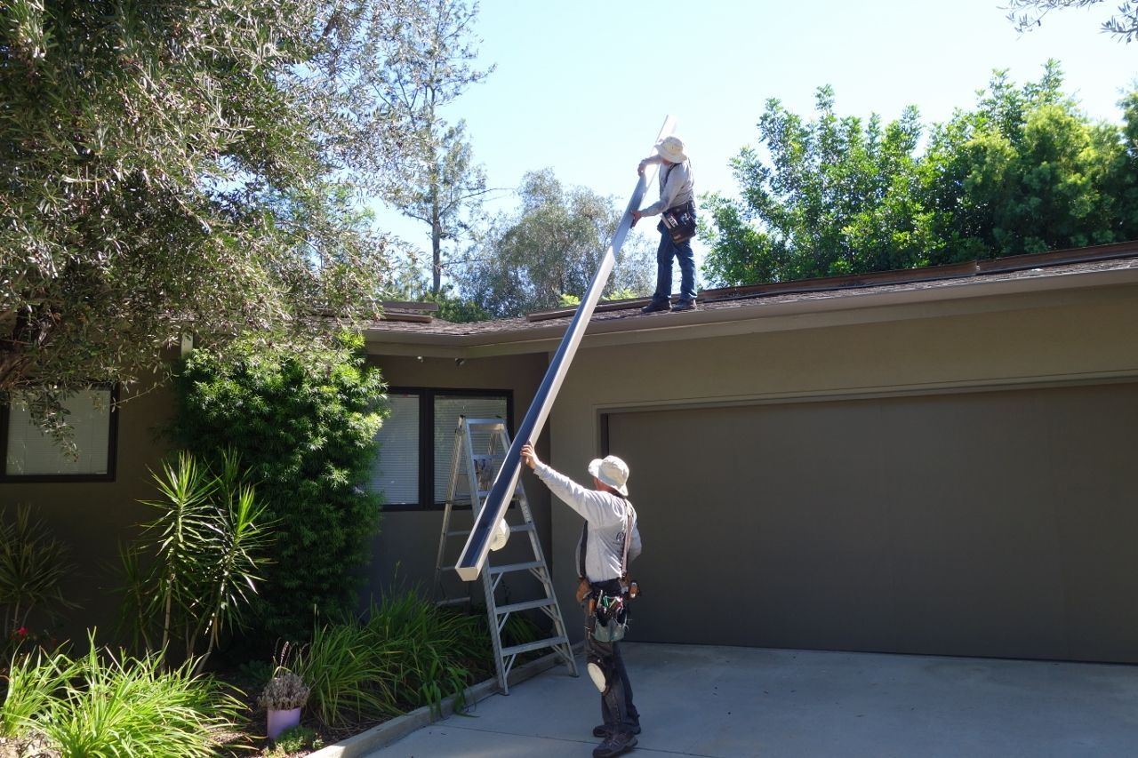 worker installing a gutter