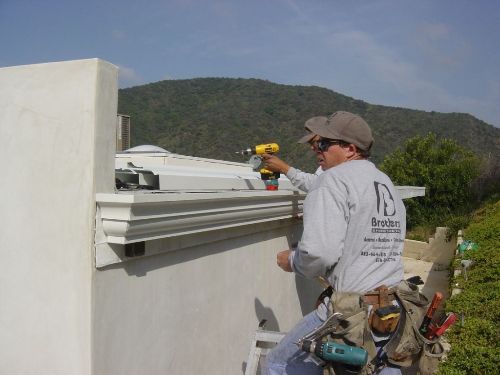 worker installing a gutter
