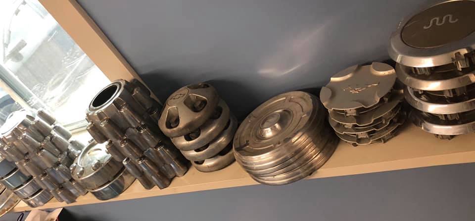 A shelf filled with a variety of metal parts.