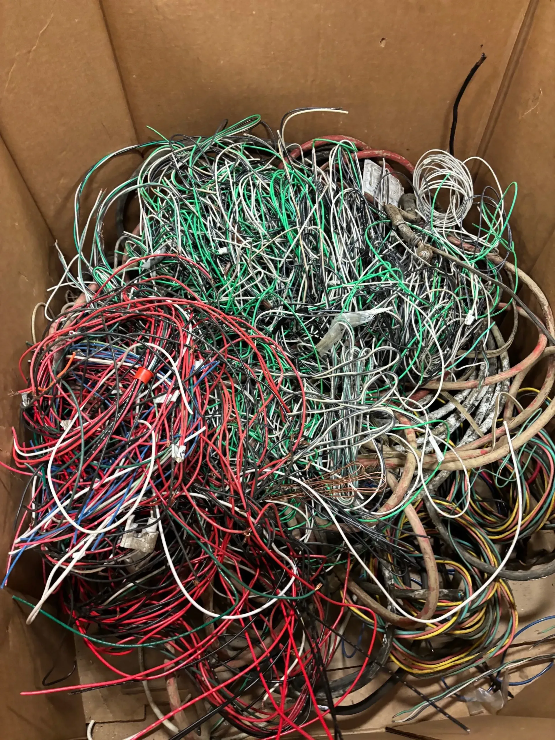 A box filled with a bunch of wires of different colors.
