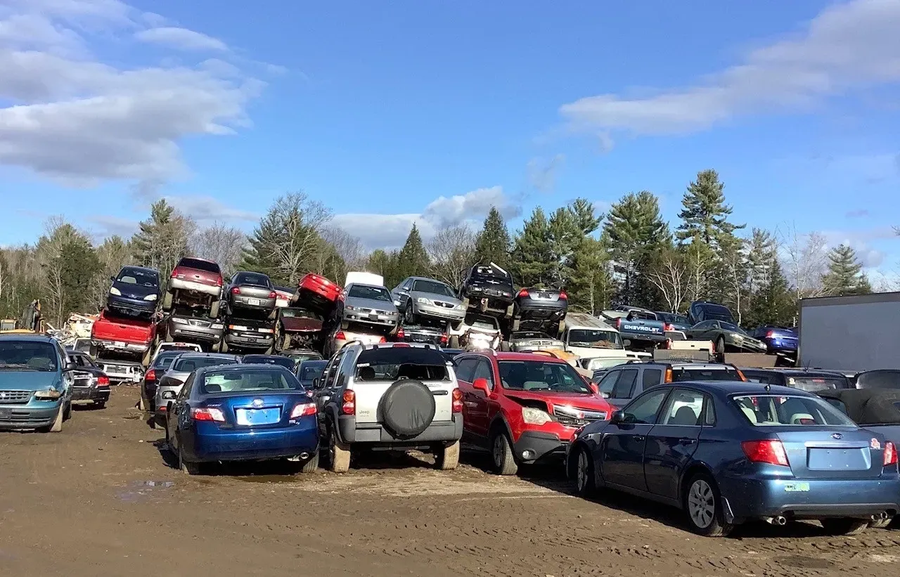 A lot of cars are parked in a lot.