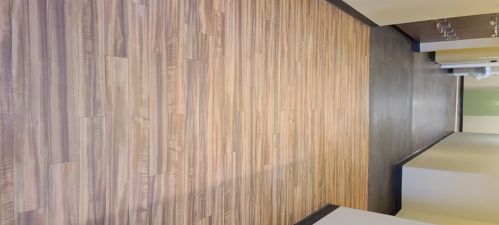 A room with a wooden floor and a wooden wall.