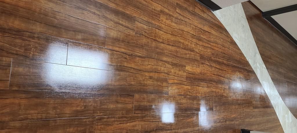 A close up of a wooden floor with a light shining on it.