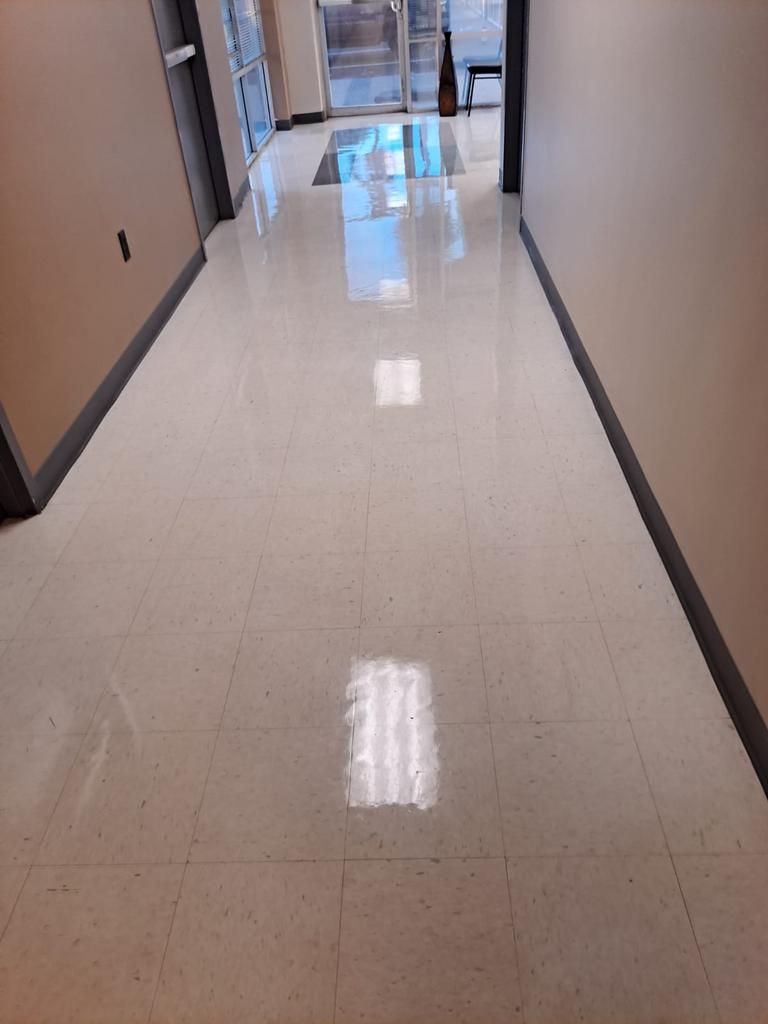 A hallway with a tiled floor and a light on the floor.