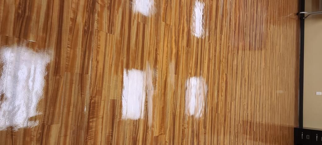 A close up of a wooden surface with white spots on it.