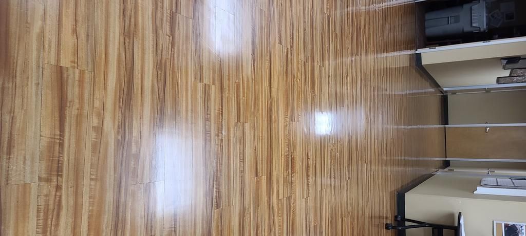 A close up of a wooden floor in a room.