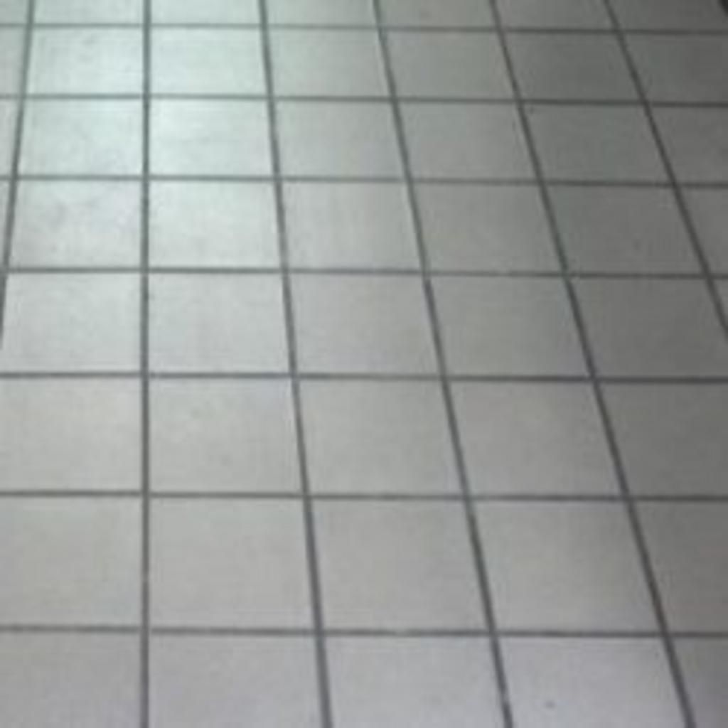 A close up of a tiled floor with a grid pattern