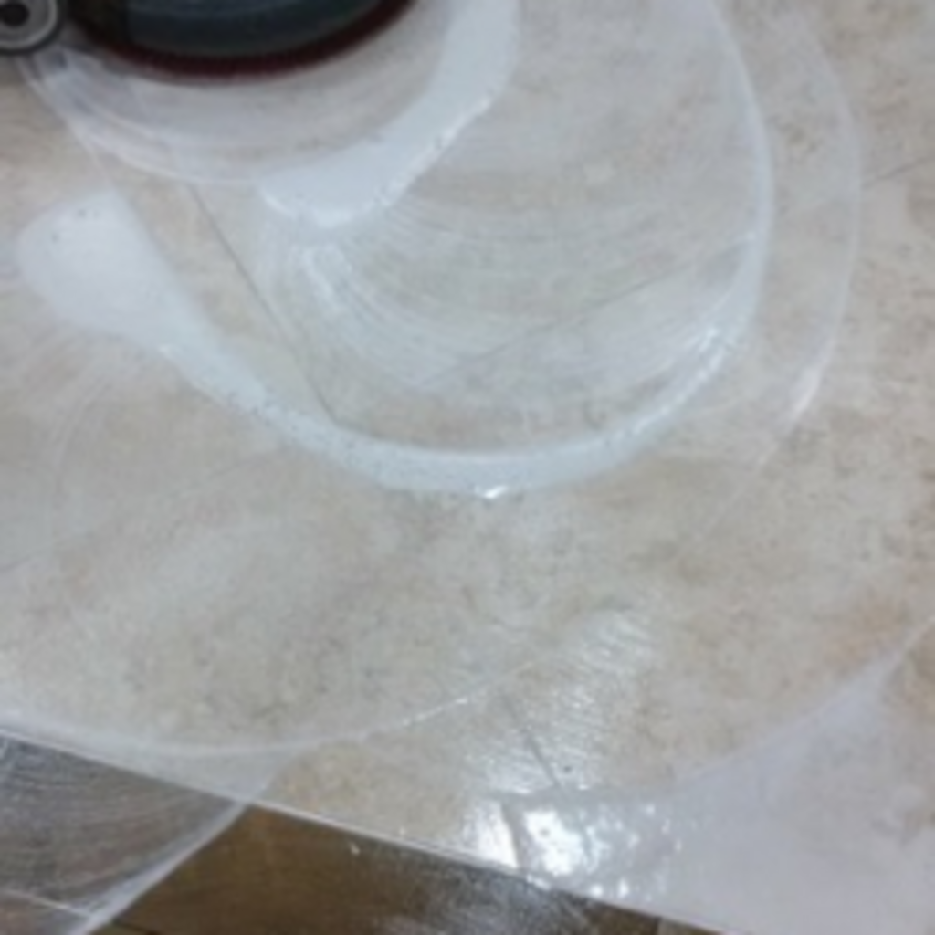 A close up of a plastic bag on a tile floor.