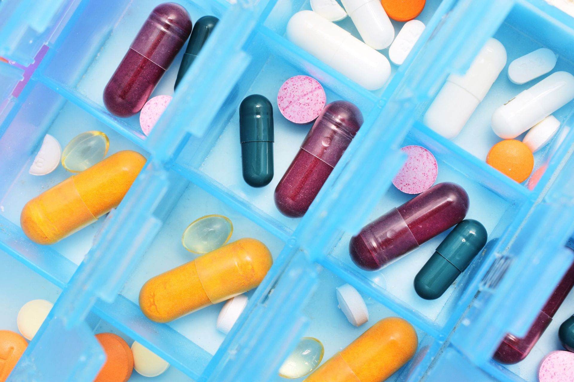 A blue box filled with many different types of pills