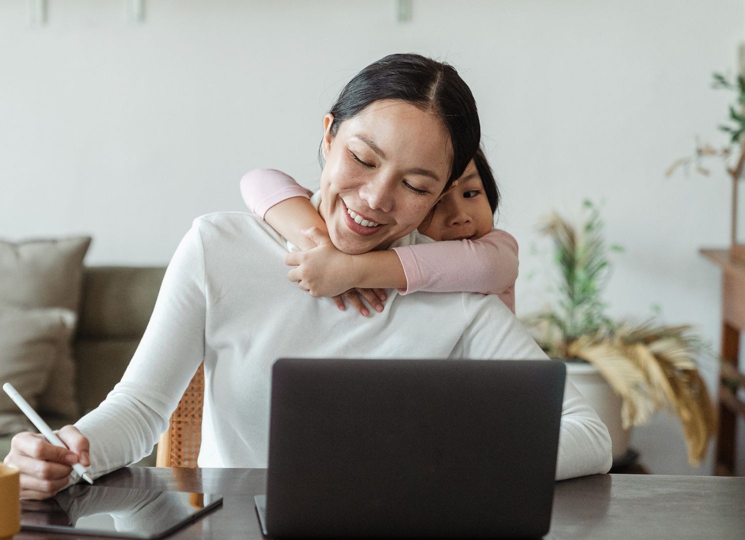 A man with a beard is smiling and wearing a backpack.