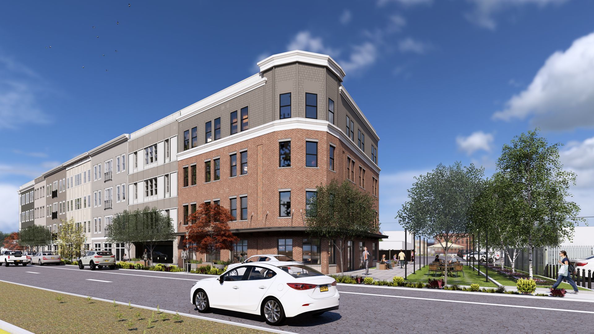 Modern apartment building with brick and grey facade, street view, sunny day.