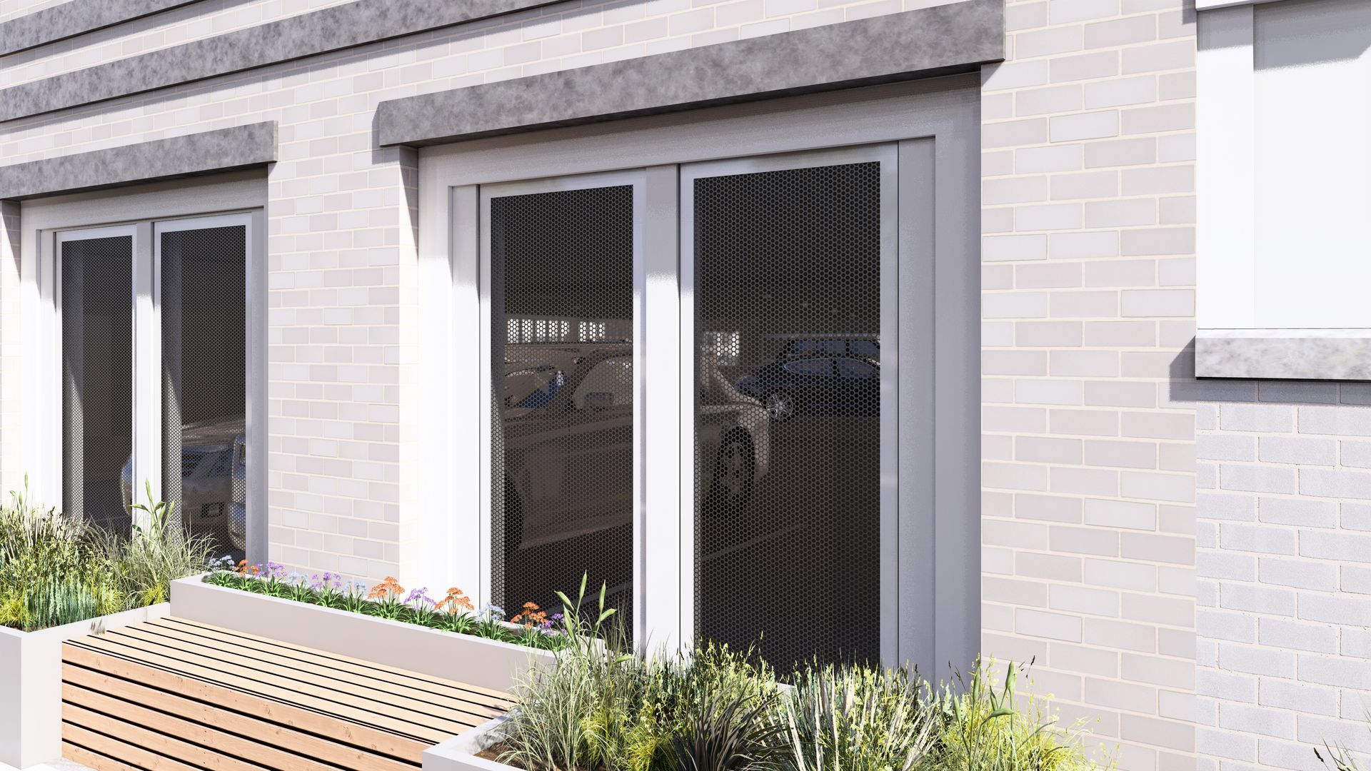 Light brick building with windows and a door. There is a small garden box with flowers.