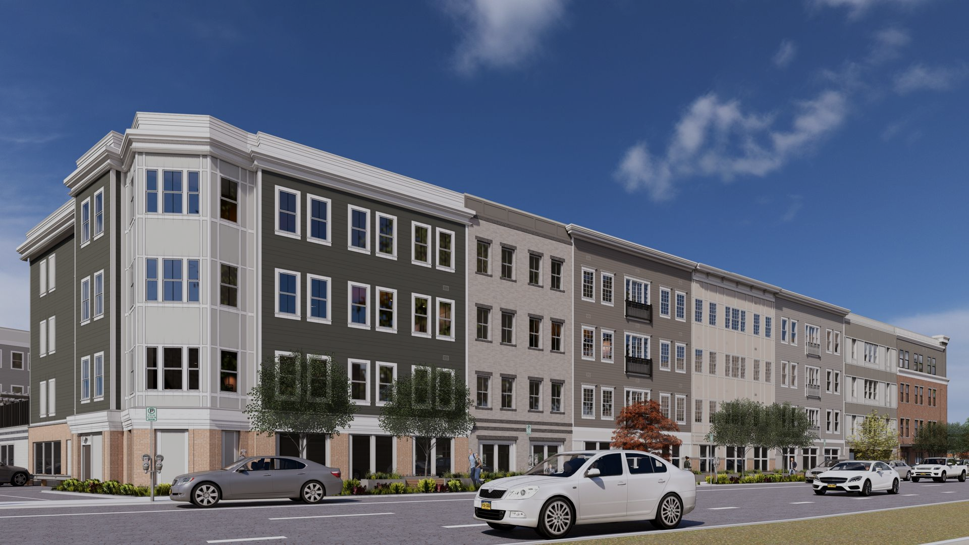 Strip mall with red and gray facades, brick, and awnings over glass doors. Asphalt parking lot.