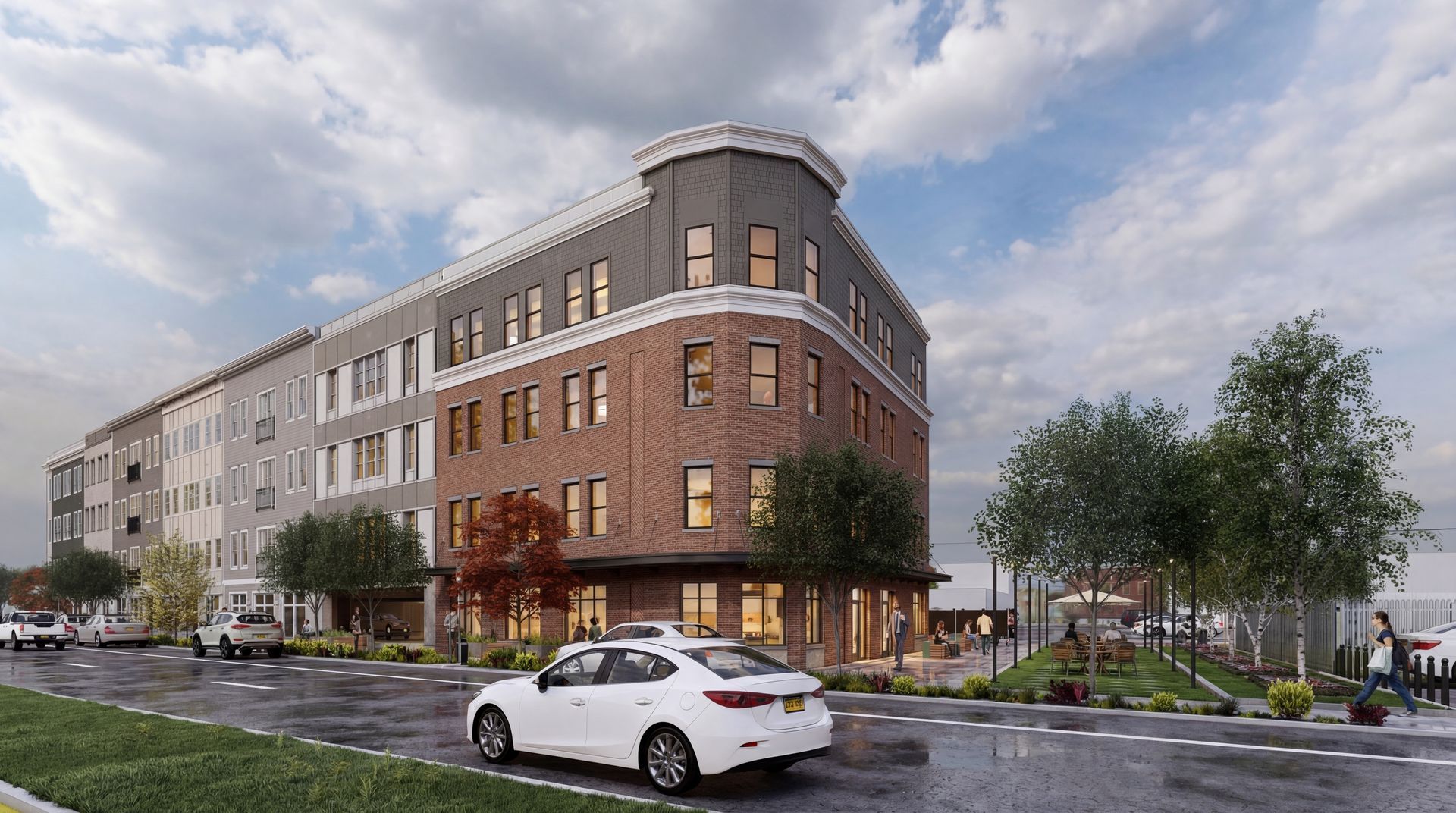 A digital rendering of a multi-story apartment building with a brick and gray exterior on a tree-lined street.