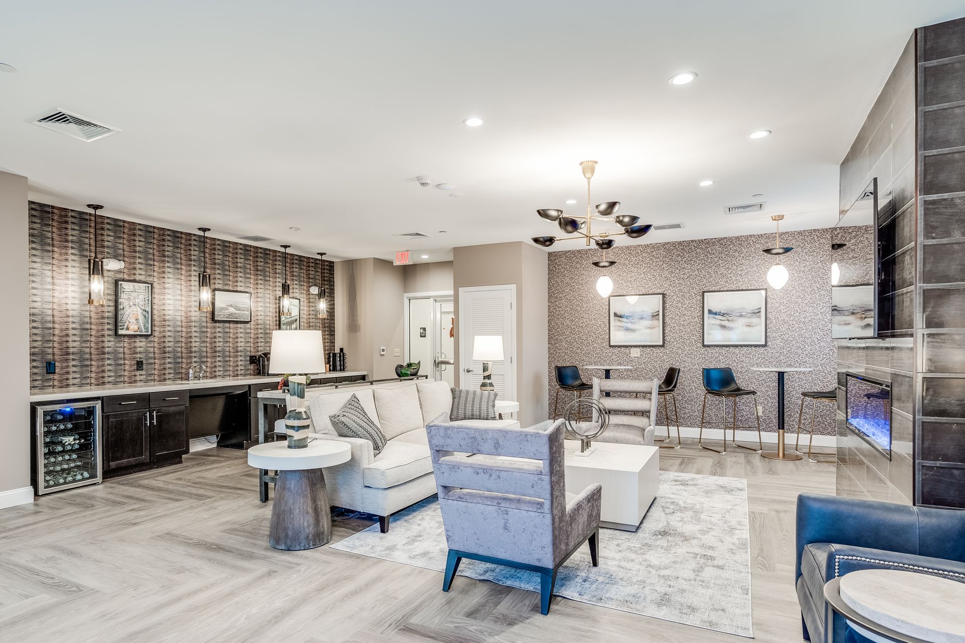 Luxurious lounge area with seating, fireplace, bar, and decorative lighting.