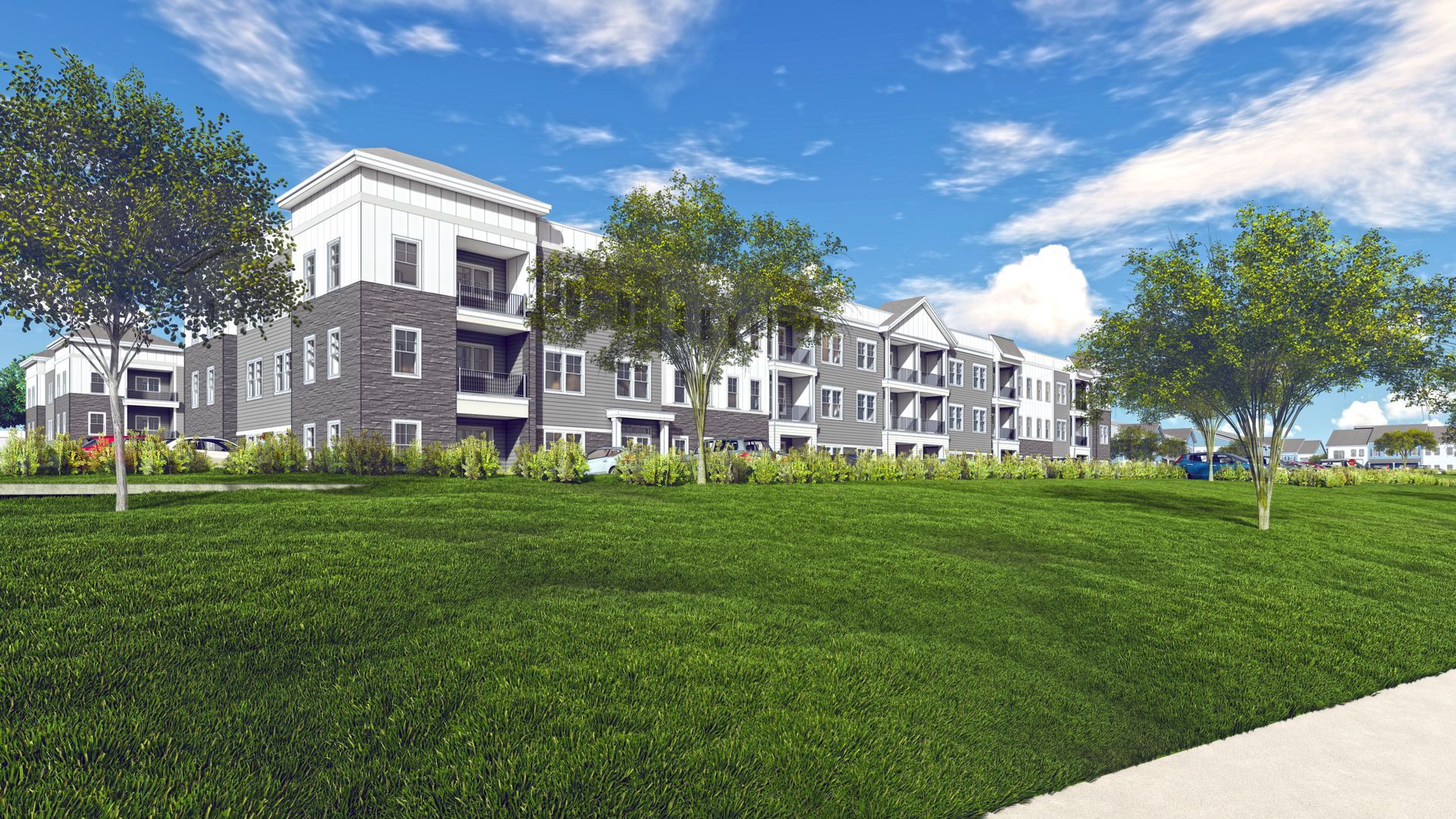Multi-story apartment building with green lawn and trees under a blue sky.