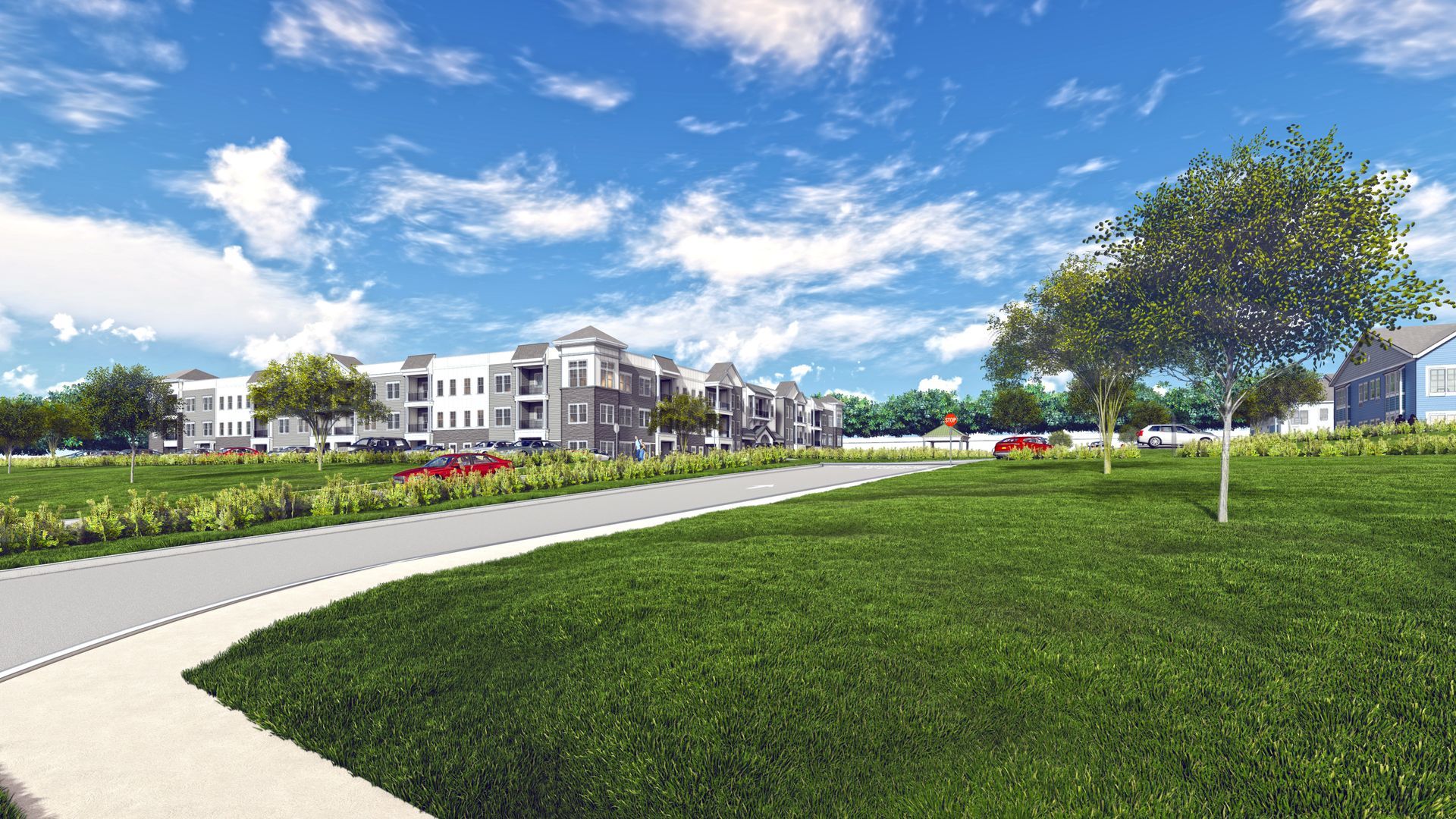 Multi-story apartment buildings with landscaping and a blue sky.