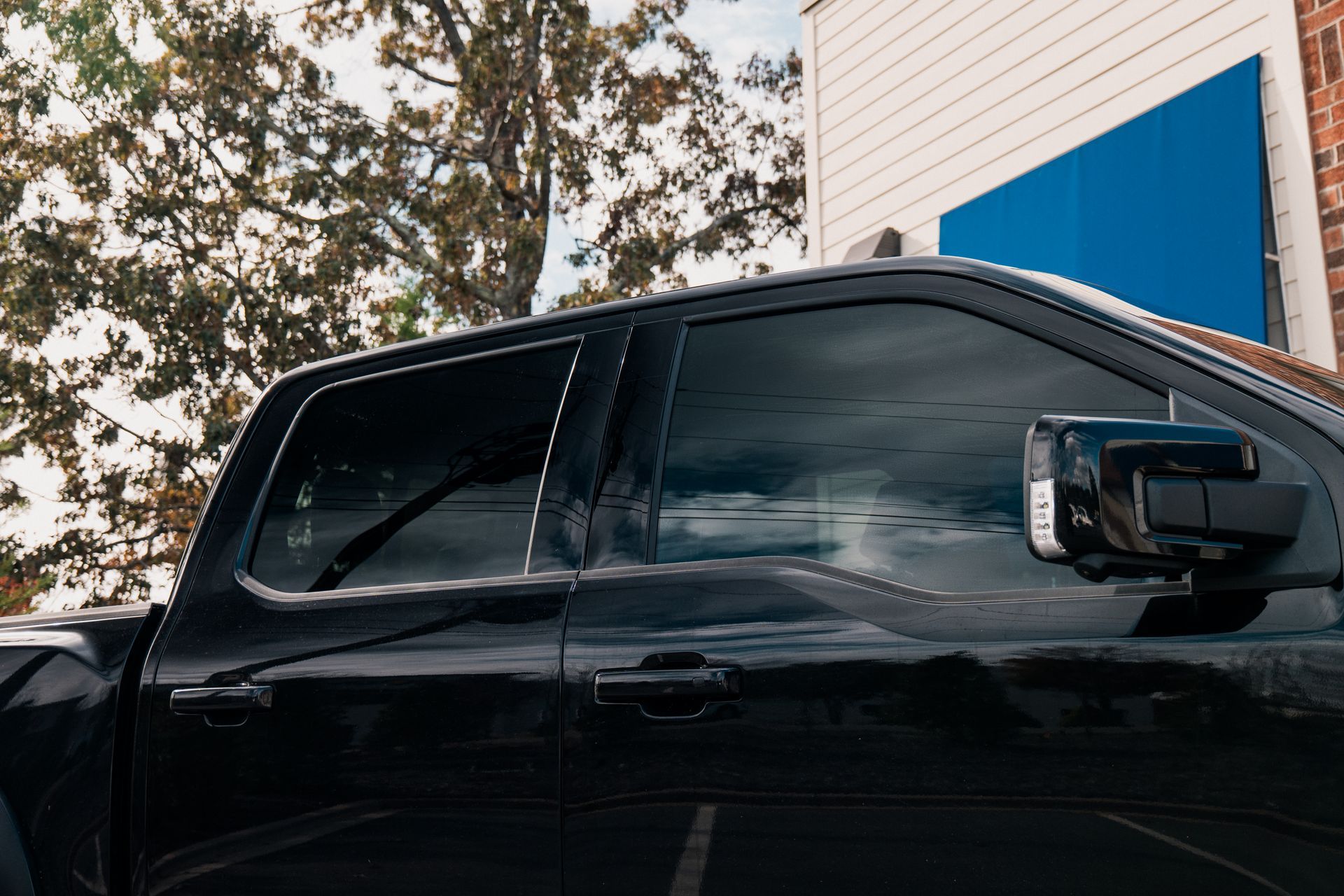 Ford Raptor with professionally installed window tint in Cornelius, NC, enhancing privacy and UV protection.