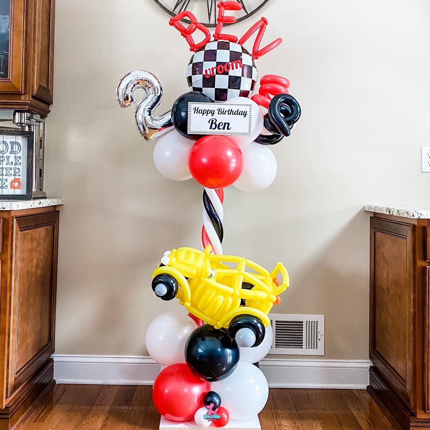 a bunch of balloons are stacked on top of each other in a room