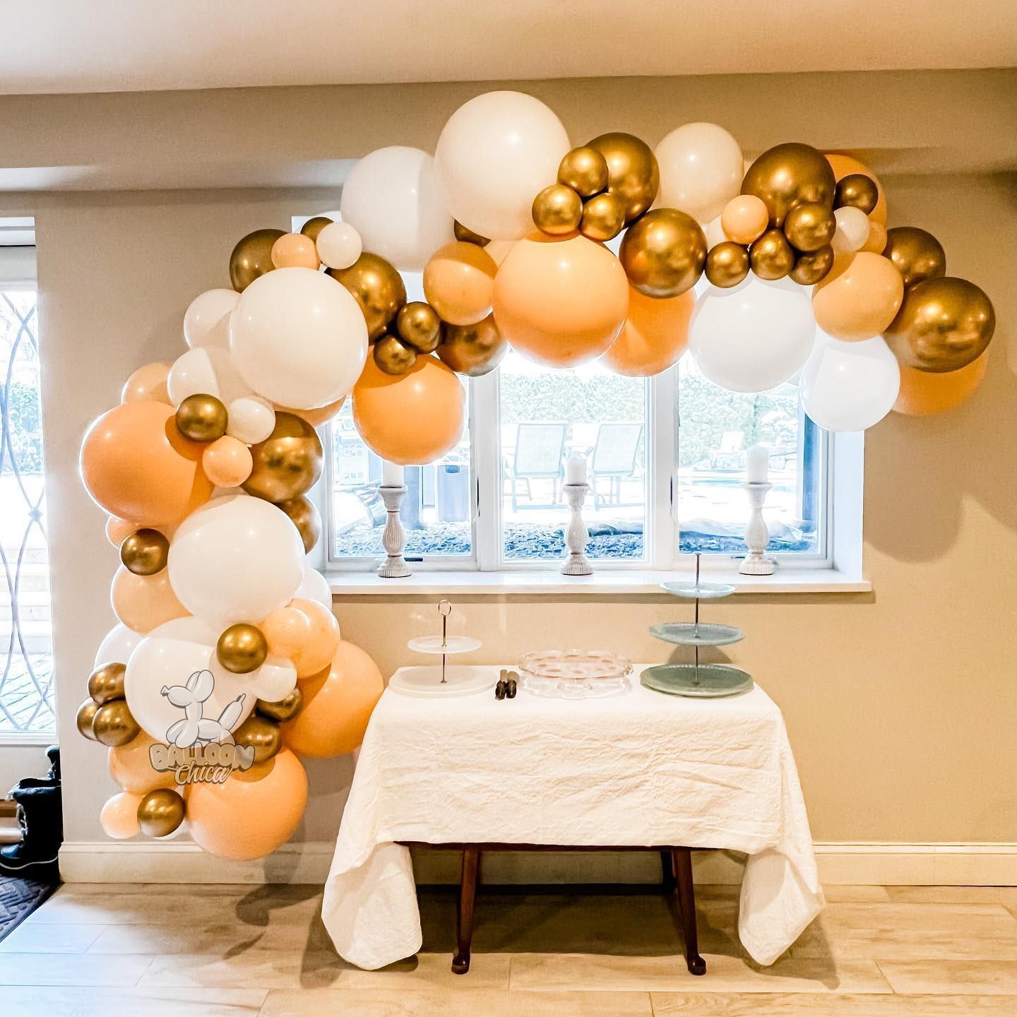 a room with a table and a bunch of balloons on the wall