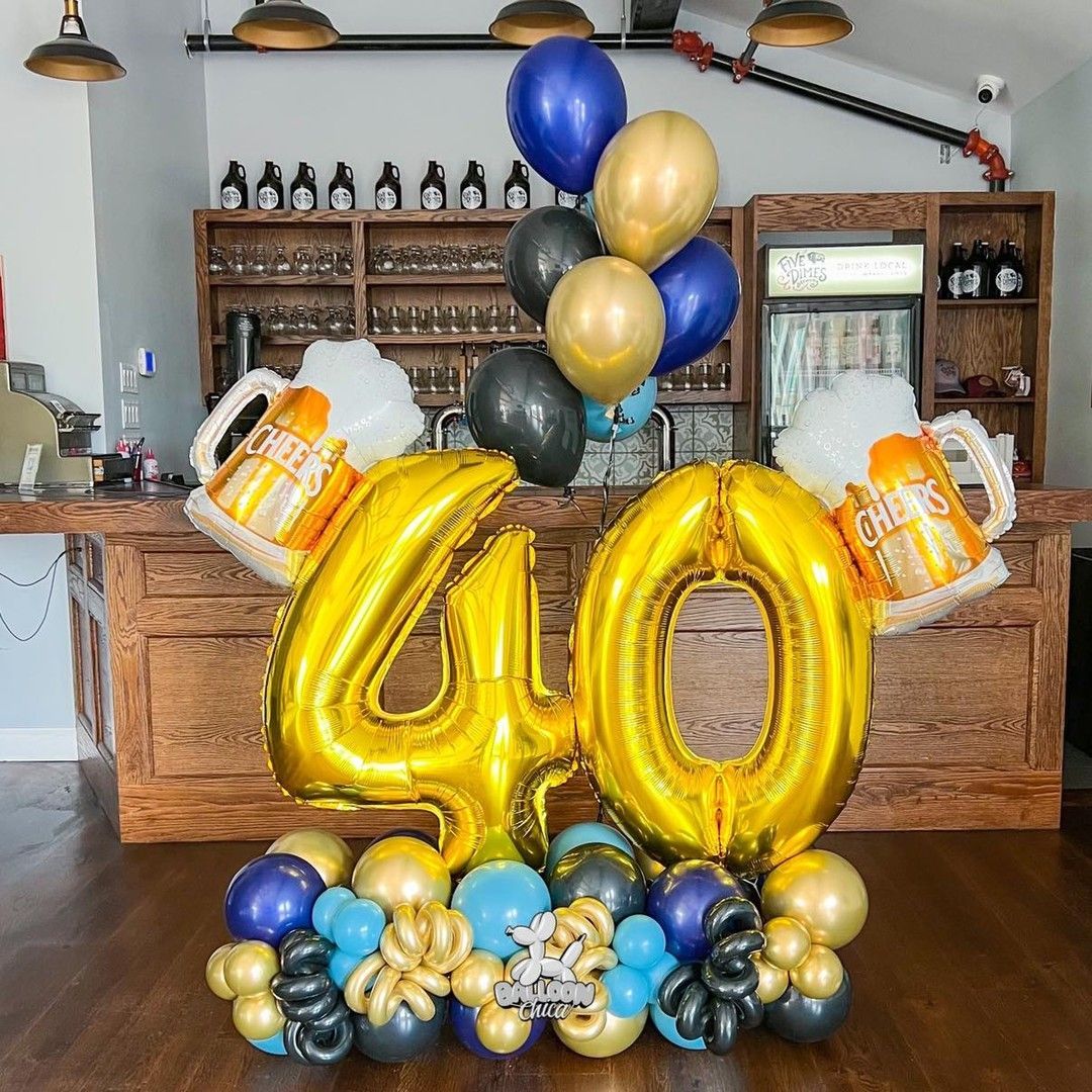 a bunch of balloons and beer mugs are sitting on a table