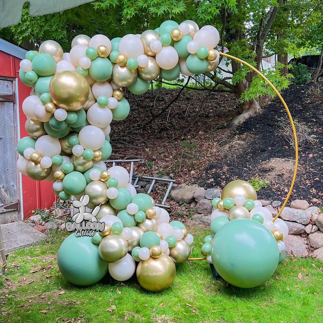 a bunch of balloons are sitting on top of a lush green field