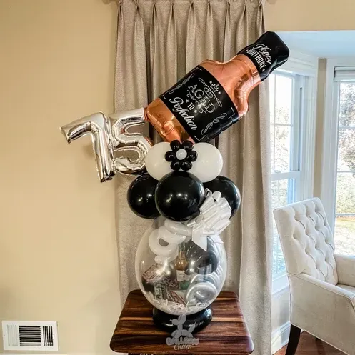 a balloon filled with a bottle of jack daniels is sitting on a table .