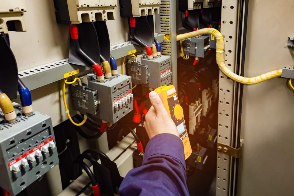 electrician inspects the power control