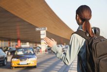 woman waving at the taxi