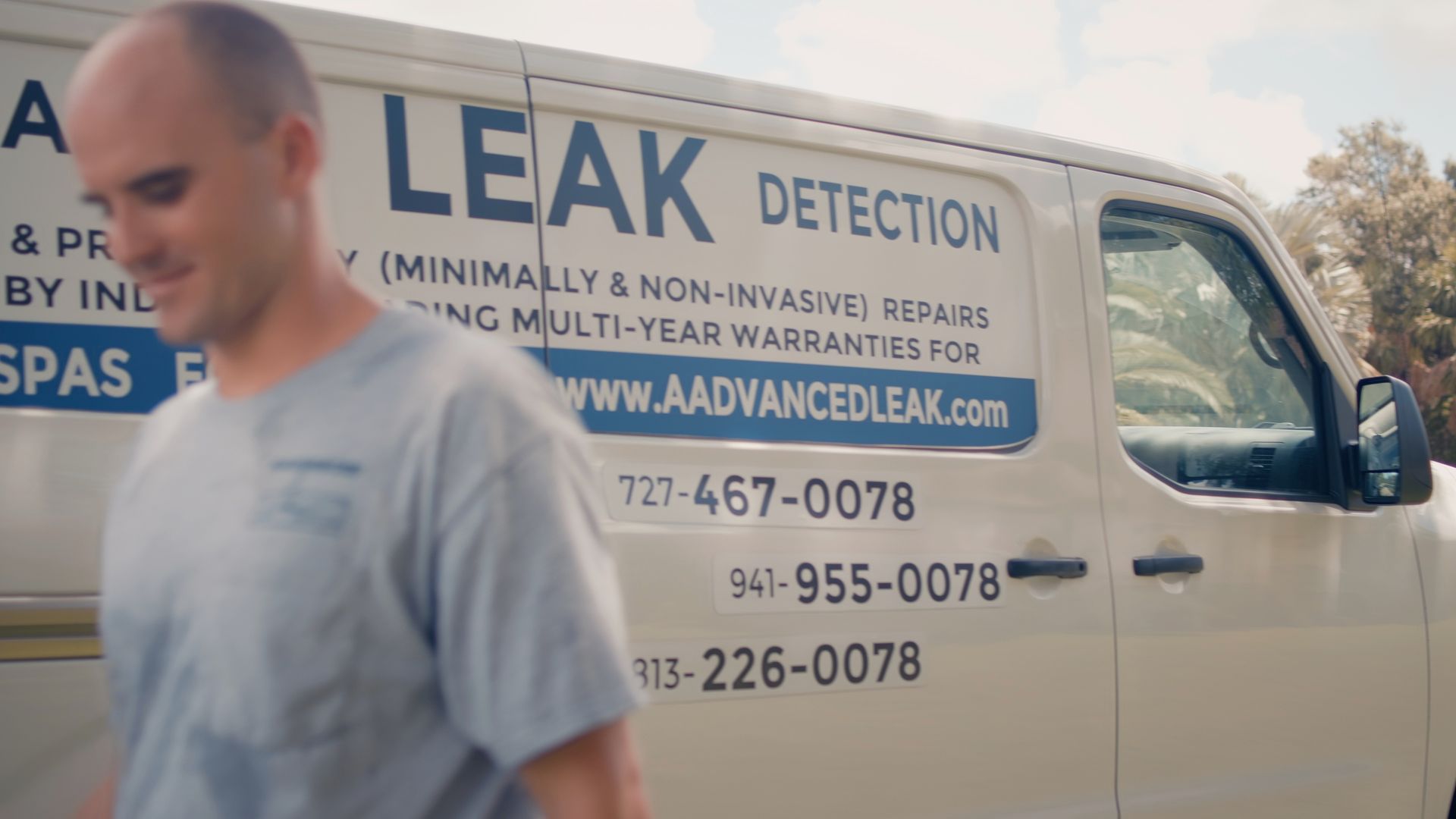 A man in front of a white van with 