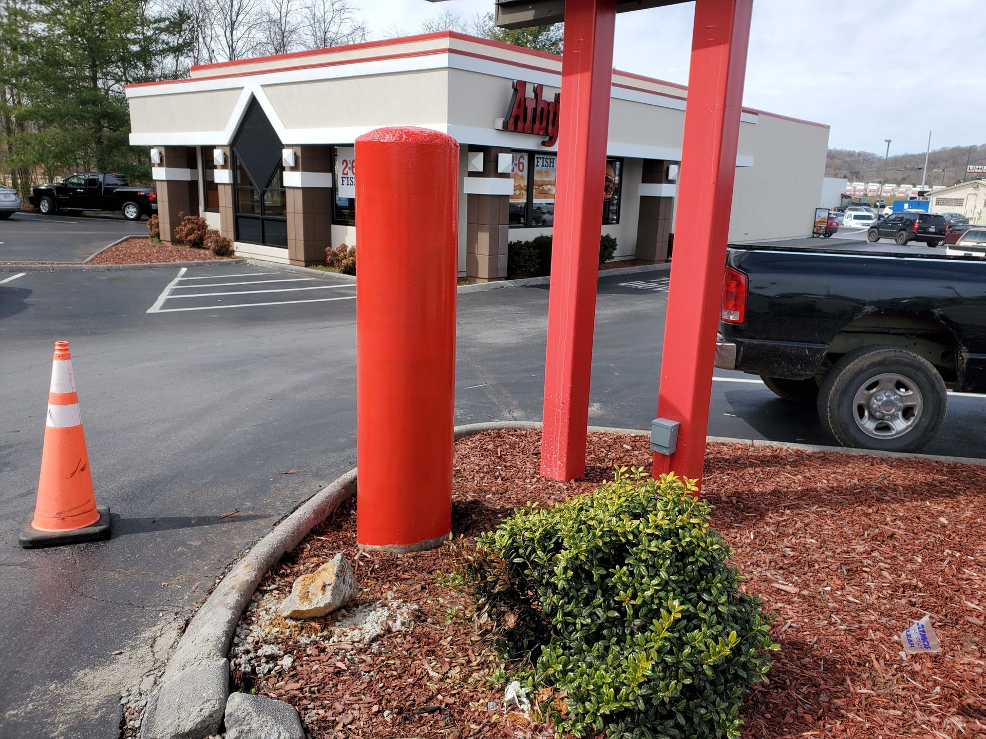 A truck is parked in front of a burger king restaurant