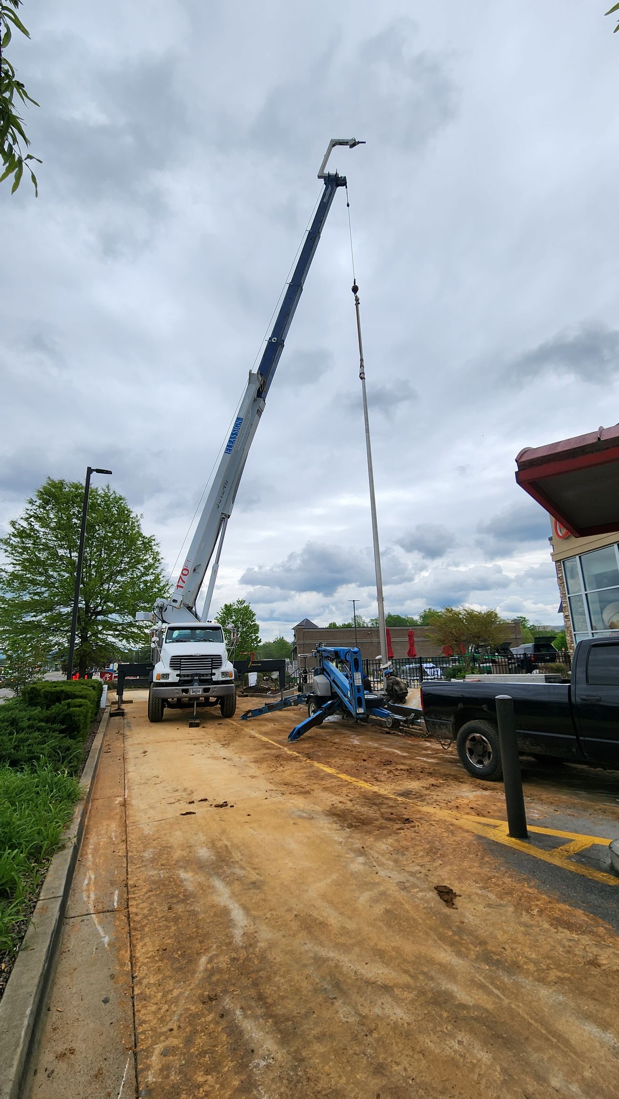A mcdonald 's sign is being worked on by a crane