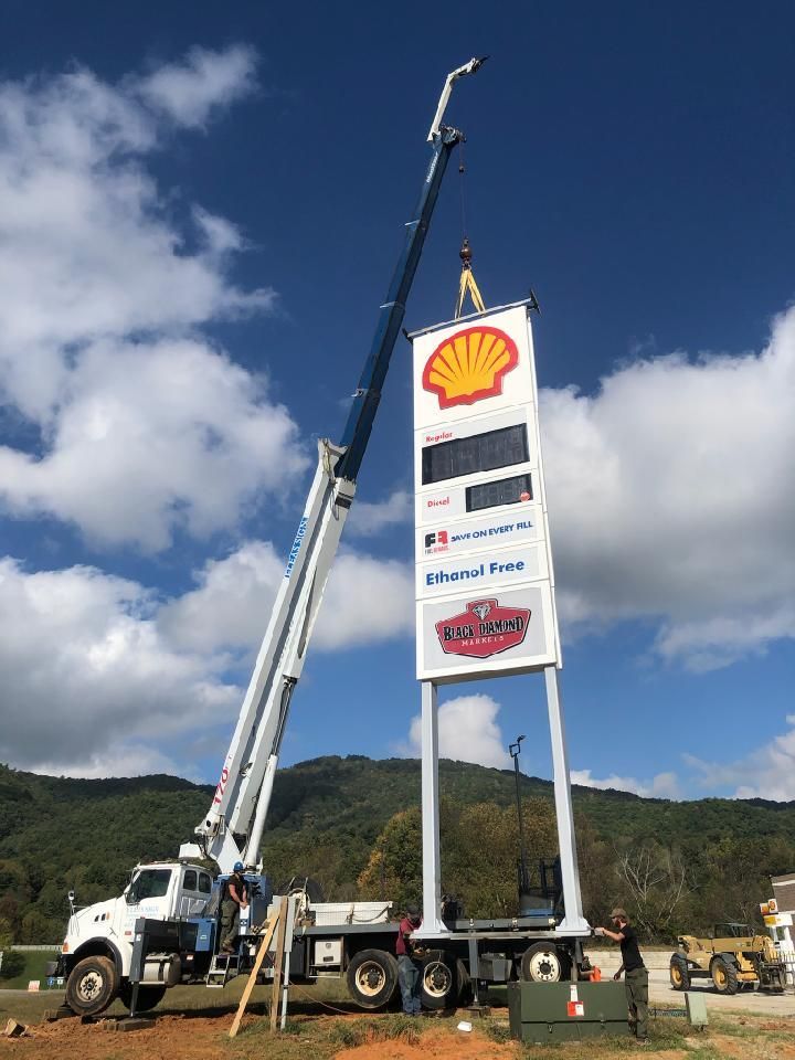 A taco bell sign is being lifted by a crane