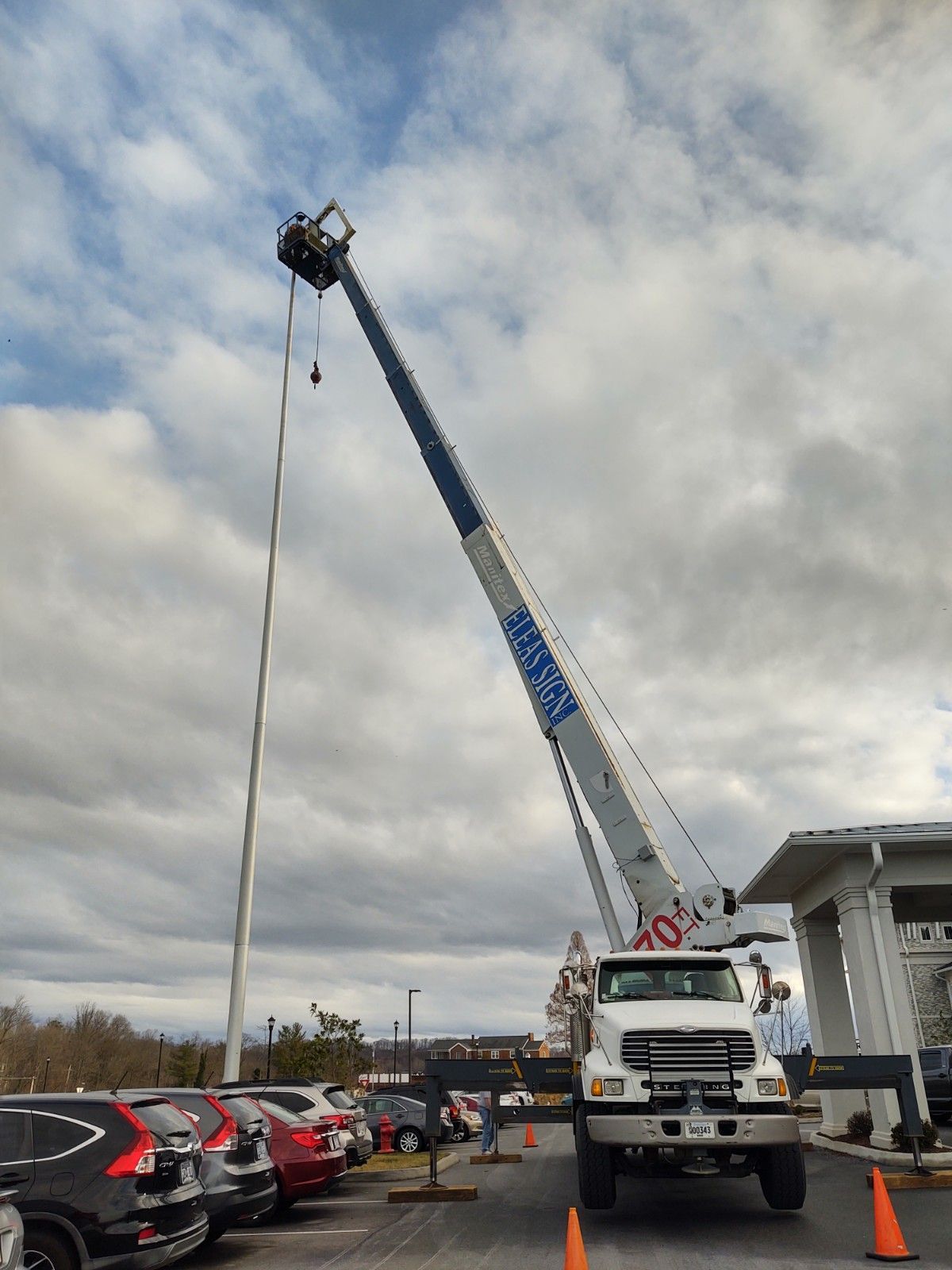 A mcdonald 's sign is being worked on by a crane