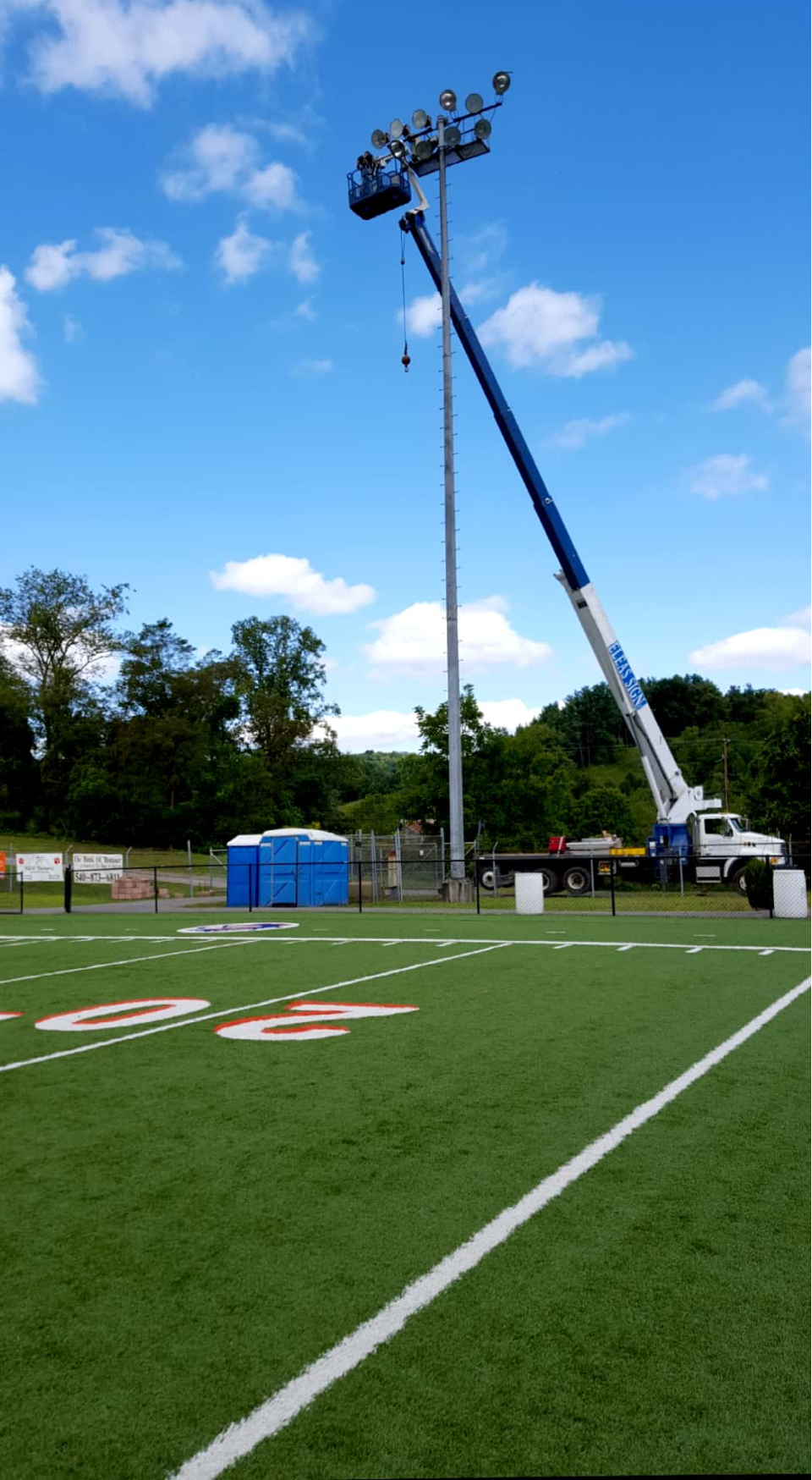 A large crane is working on a football field