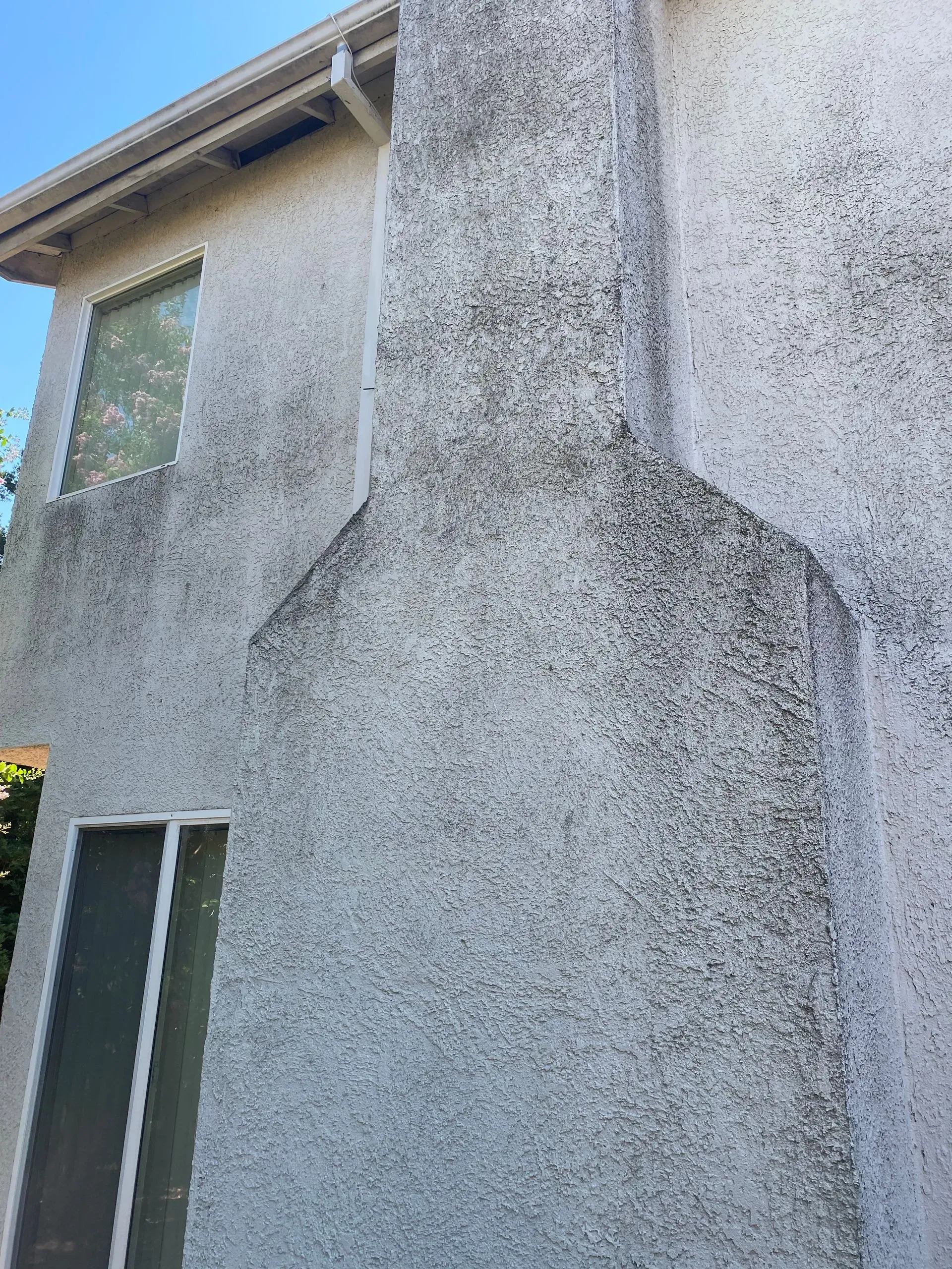 A house with a chimney on the side of it.