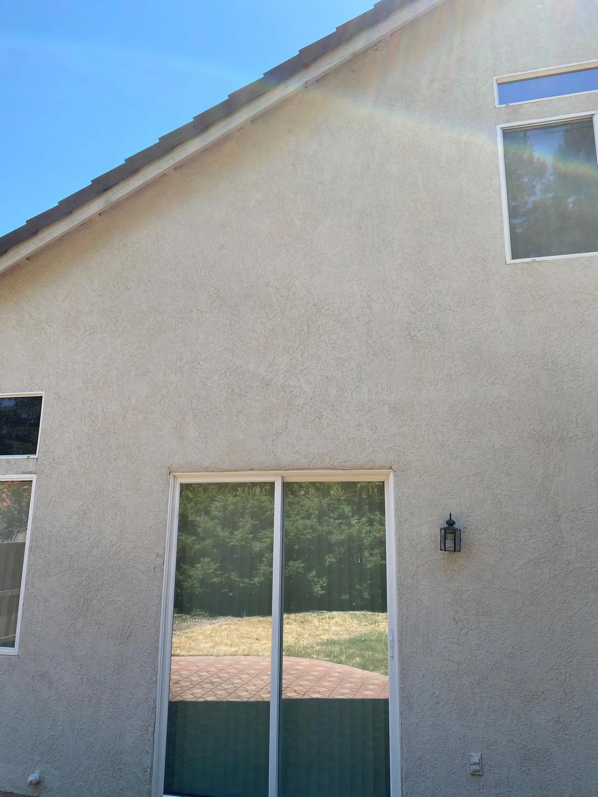 A house with a lot of windows and a sliding glass door