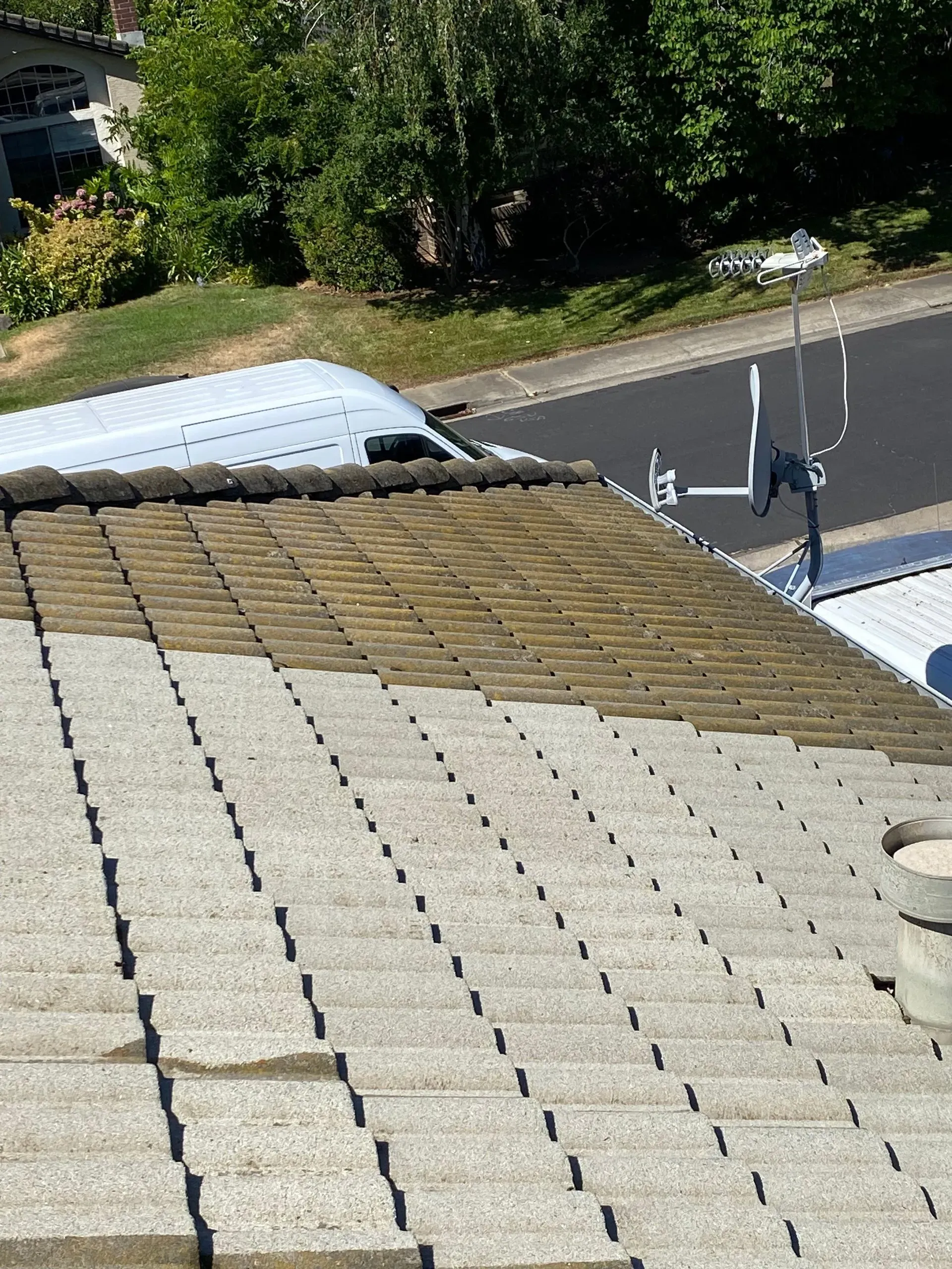 A white van is parked on the roof of a building.