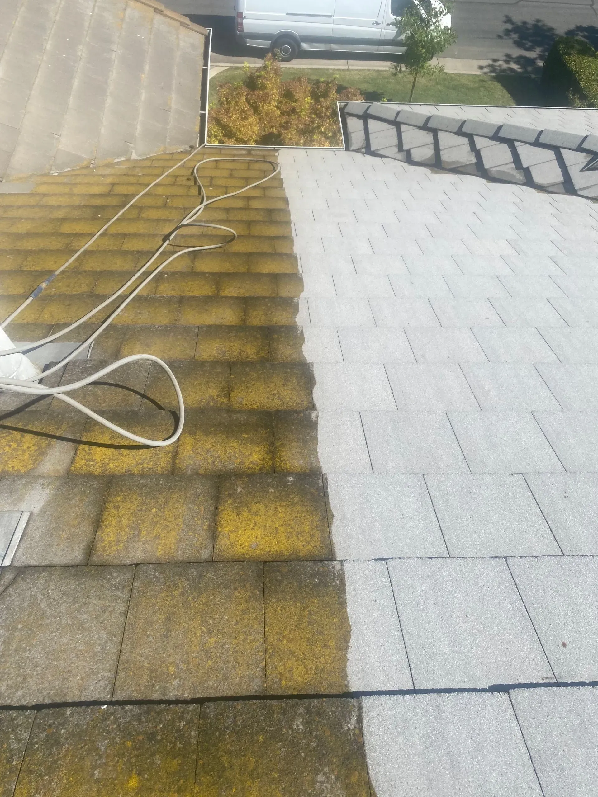 A picture of a roof before and after being cleaned.