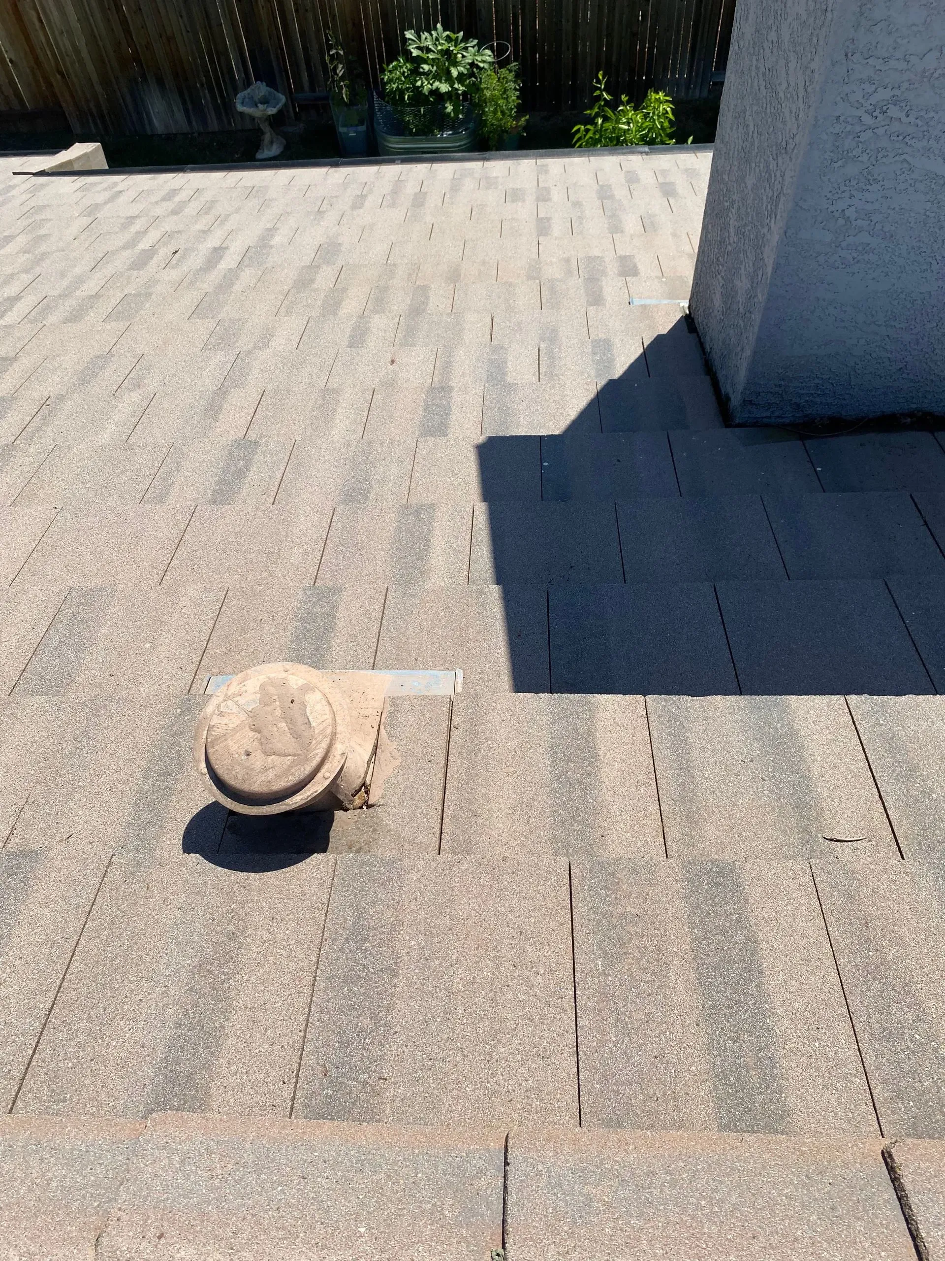 A hat is laying on the ground on a brick patio.