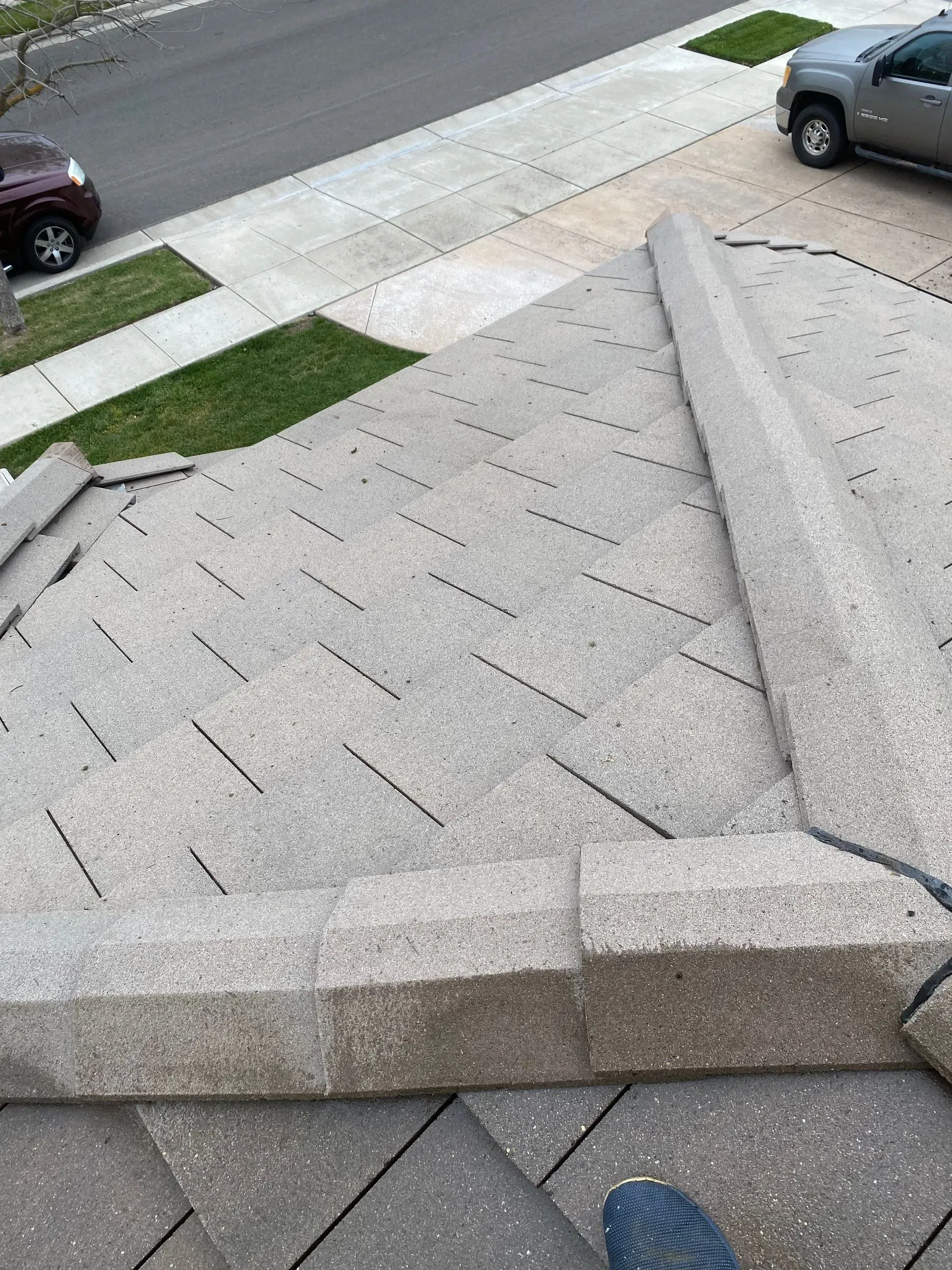 A car is parked on the side of the road next to a concrete staircase.