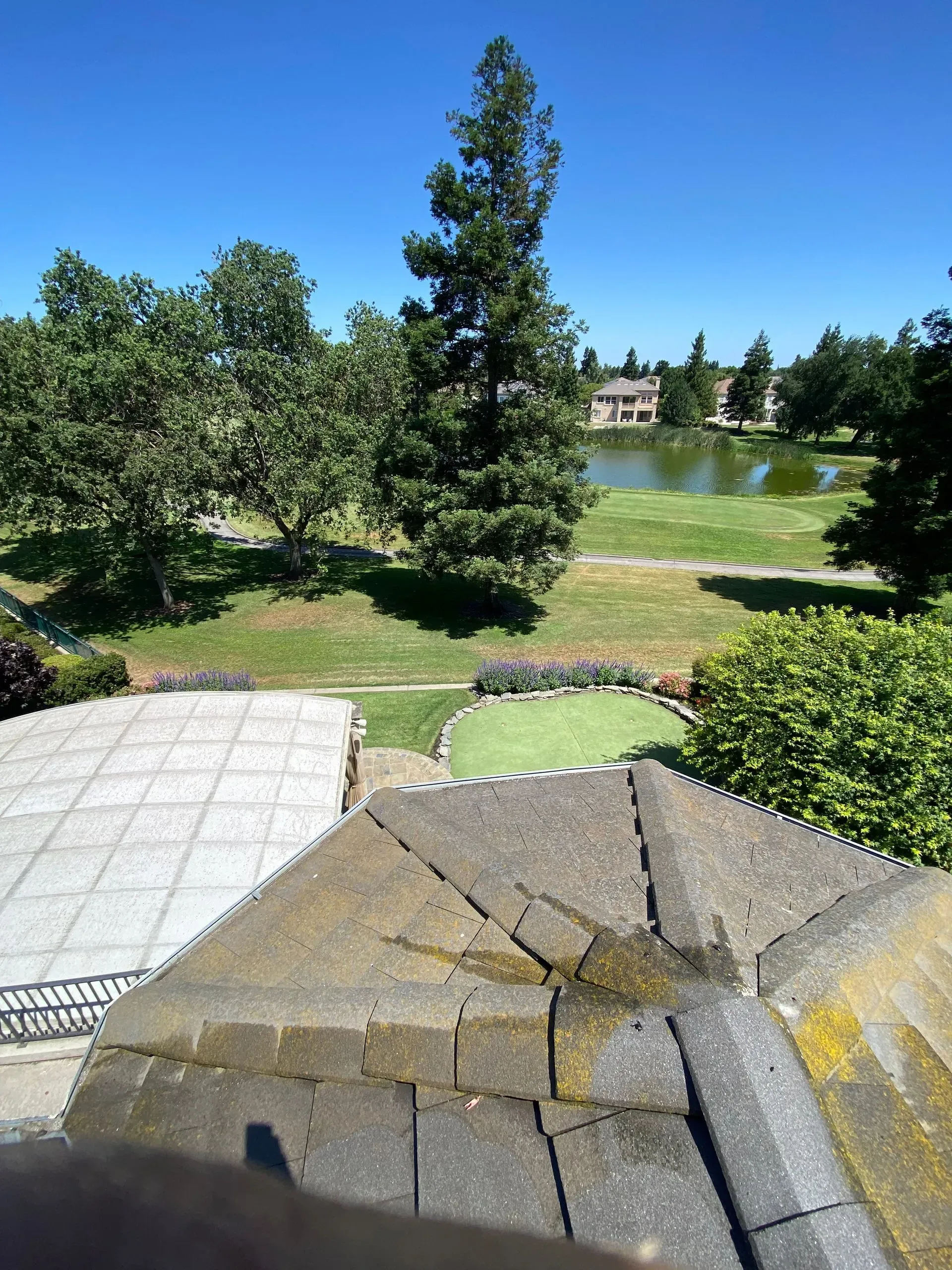 A view of a golf course from the roof of a building