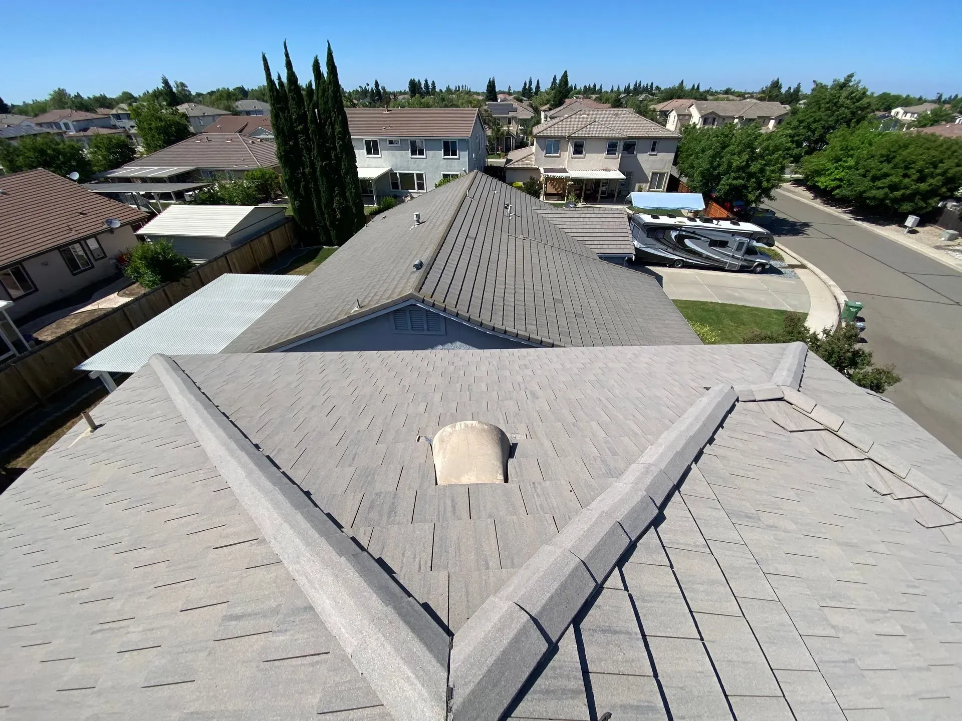 An aerial view of a house with a triangle shaped roof