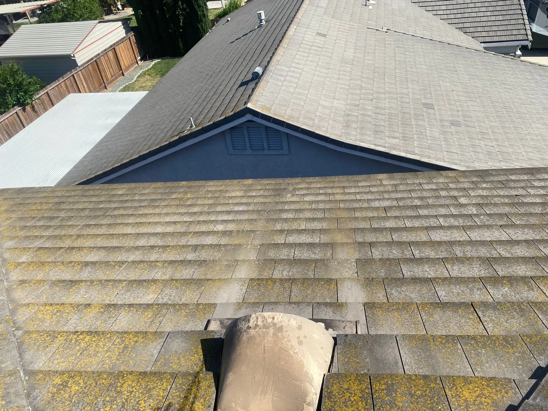 A roof of a house with a chimney on it.
