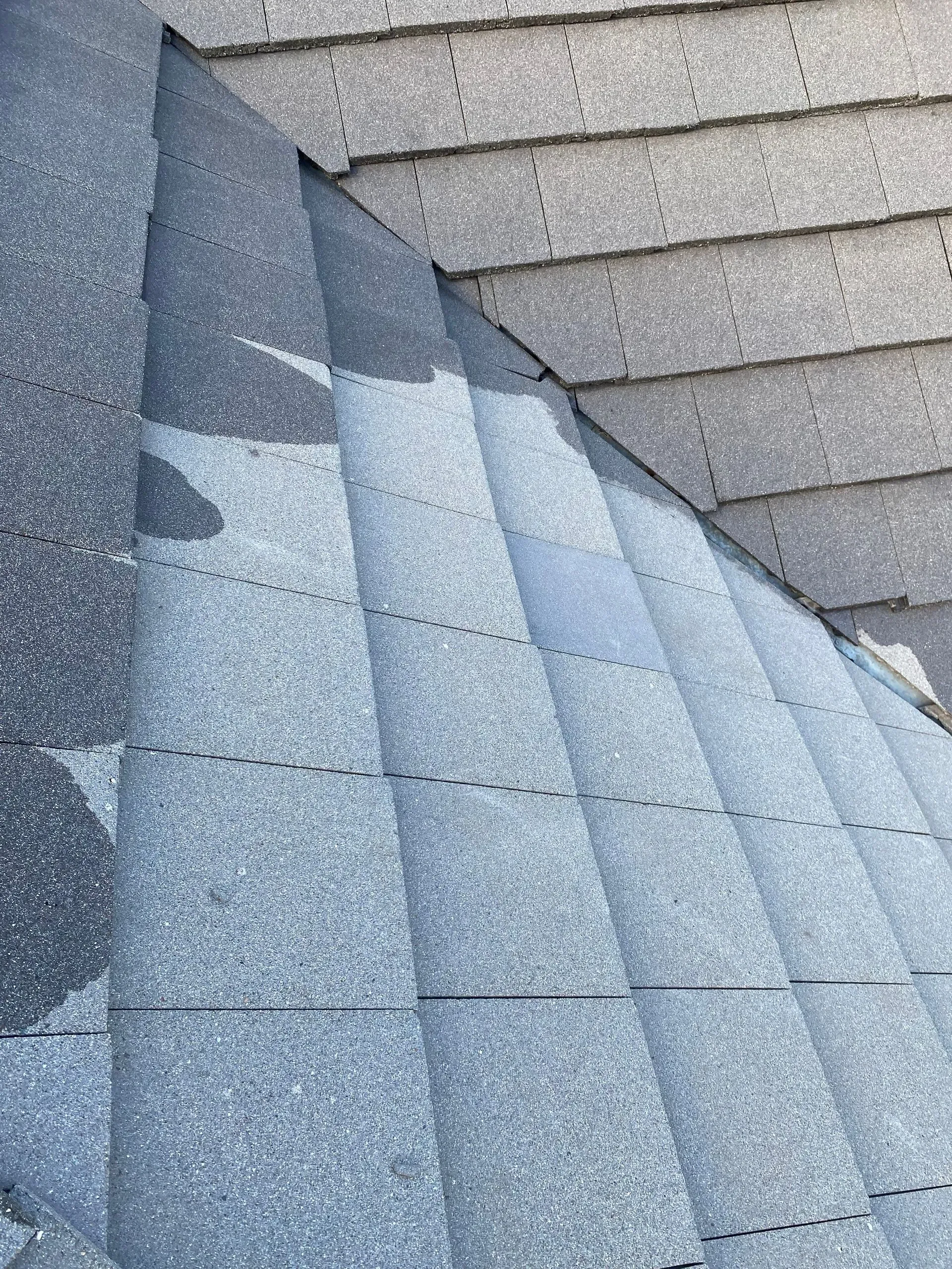 A close up of a roof with a staircase in the background.